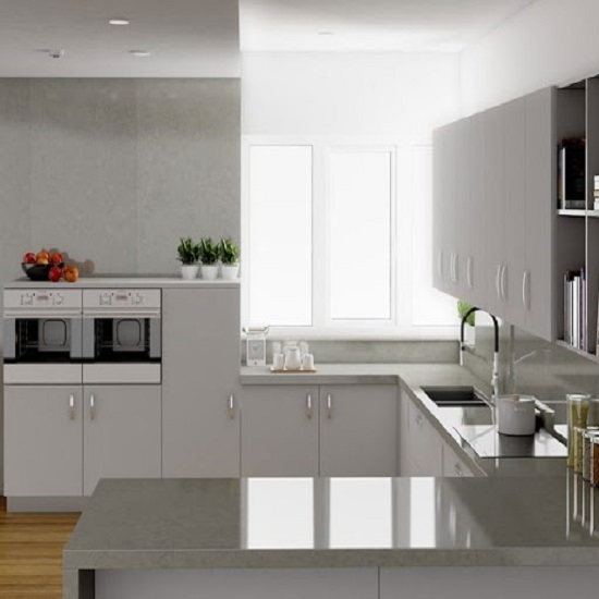 A modern kitchen with Unistone Carrara Santorini worktops and white cabinets