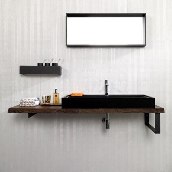 A vanity top in Absolute Black Granite with a mirror and wallpaper