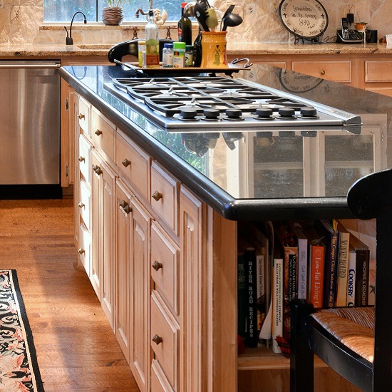 A kitchen with white cabinets and Absolute Black Granite worktops