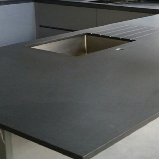 A Kitchen worktop in Absolute Black granite in a leather finish with white cabinets