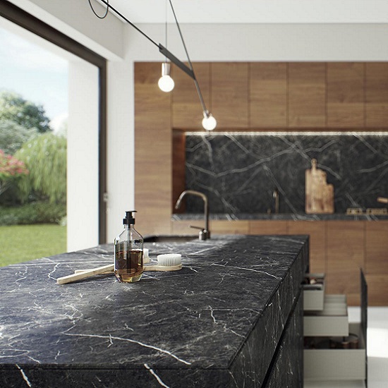 Caesarstone Smokestone kitchen island with a bottle of soap and two brushes in a luminous kitchen