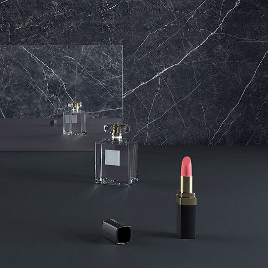 Caesarstone Smokestone wall as a background of a mirror, a bottle perfume and lipstick