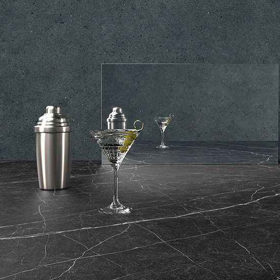 Caesarstone Smokestone worktops, a shaker and a cocktail glass with a mirror and a grey cement grey background