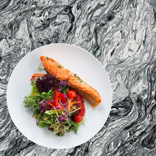 A Cosmic White granite worktop with a food plate