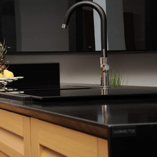 a kitchen countertop in Quartzforms Lavic Black 30mm thickness and wooden cabinets