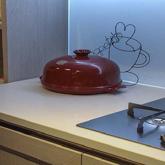 A Quartzforms MA Beige worktop in a modern kitchen with a hob and a red bread container