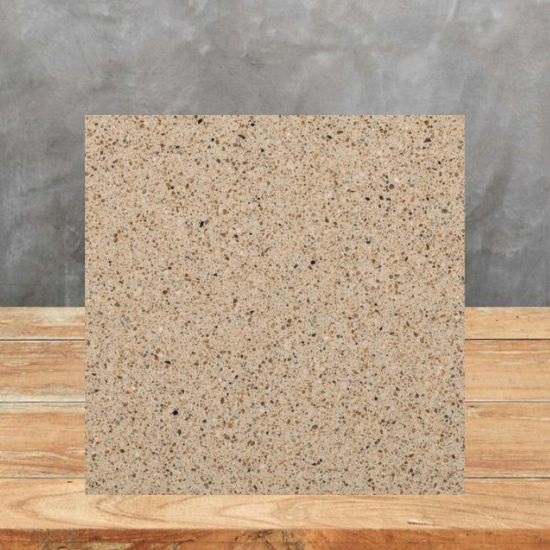a sample oA slab of Quartzforms Pebble Cappuccino quartz with a grey wall behind