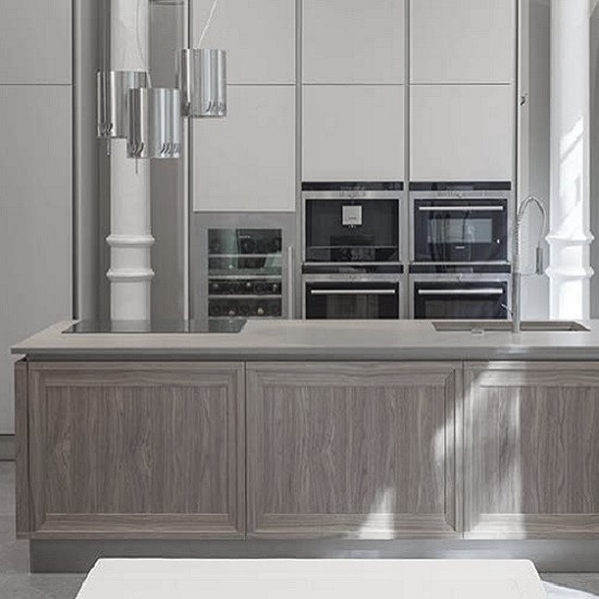 A contemporary kitchen with Quartzforms QF Ash Grey quartz worktops and wooden front, and white cabinets behind