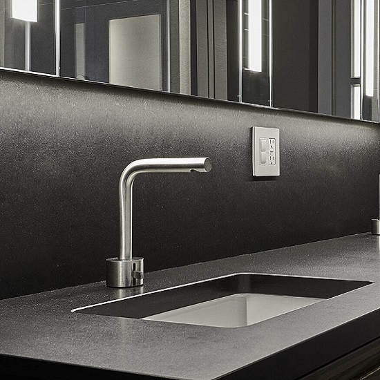 a vanity top in Quartzforms QF Black quartz in Spacco finish with a steel tap and sink