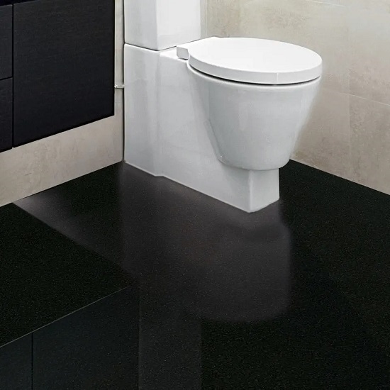 A bathroom floor in Absolute Black Granite and a white toilet