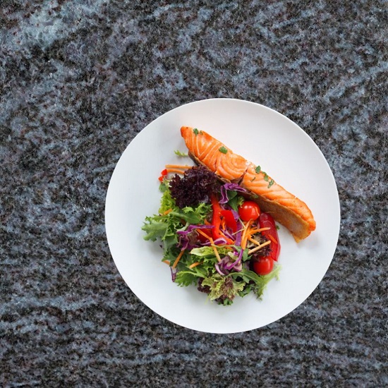A plate of food on a Bahama Blue granite worktop