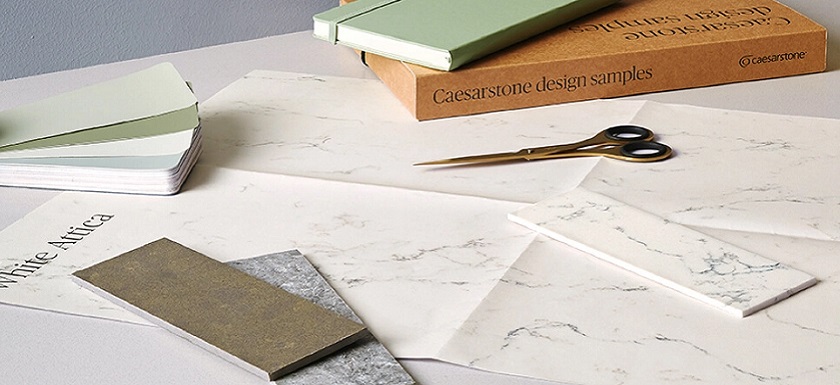 Caesarstone Samples Free, scissors, and a book on on a kitchen worktop