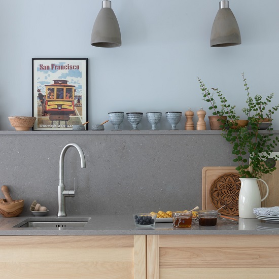 a photo of a blue kitchen with CRL Quartz Grey Mist worktops