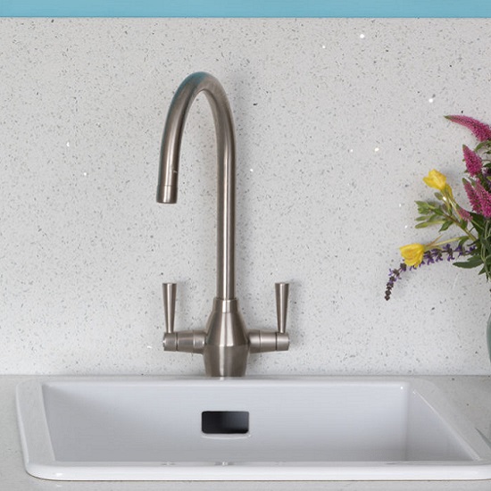 a kitchen worktop and matching splashback made from CRL Quartz Reflection, a steel tap and flowers