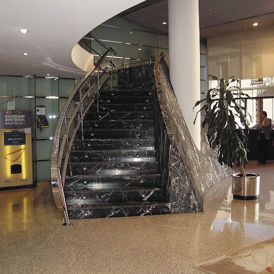 a Nero Marquina marble staircase in a hallway