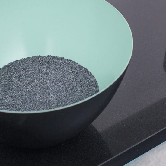 a photo of Quartzforms Add top Crystal Black quartz worktop with a bowl with black powder on it