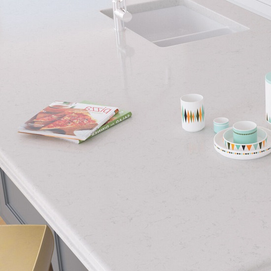 a a worktop in Quartzforms Brazilian Canadian White quartz worktop with a magazine and tea cups on it