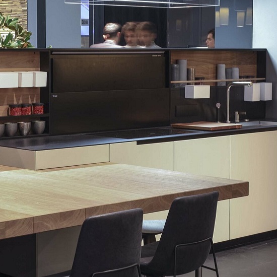 a modern kitchen with light wood cabinets and Quartzforms Extreme Night Black quartz worktops