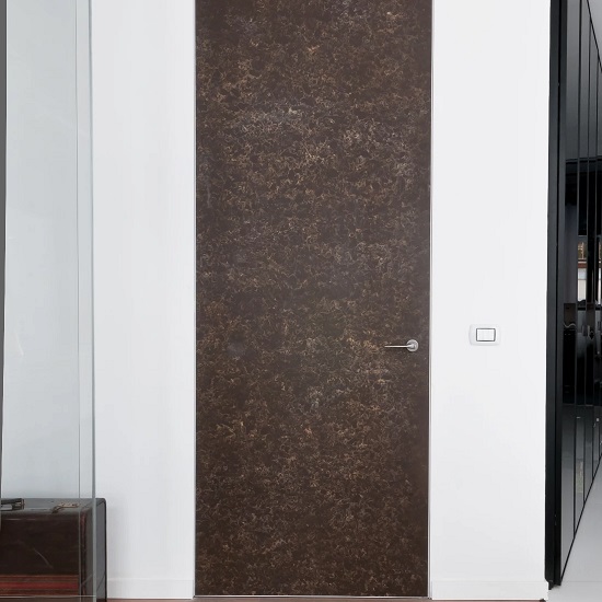 a white wall and a door covered in Quartzforms Imperial Brown