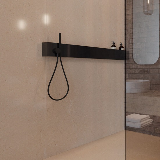 a bathroom wall with Quartzforms Planet Saturn quartz cladding and a black shelf and shower