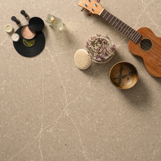 a Quartzforms Planet Saturn worktop with a guitar and small objects on it