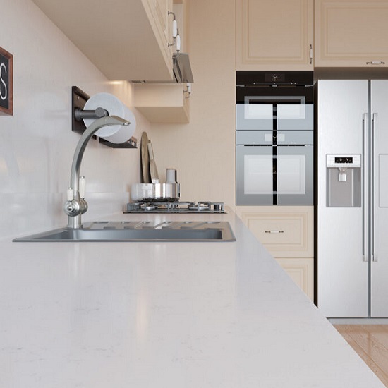 a cream kitchen with Quartzforms Veined Bernini worktops, steel appliances and wooden cabinets