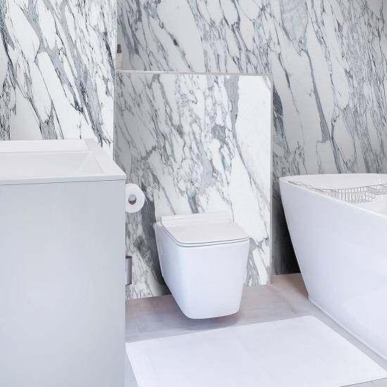 a photo of a bathroom with Arabescato marble on the walls
