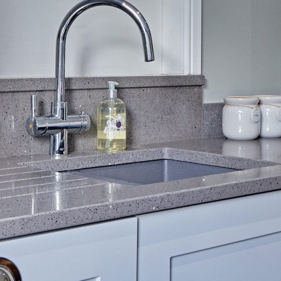 a CRL Quartz Grey Reflection kitchen worktop, a tap, a soap bottle, and two salt & pepper containers