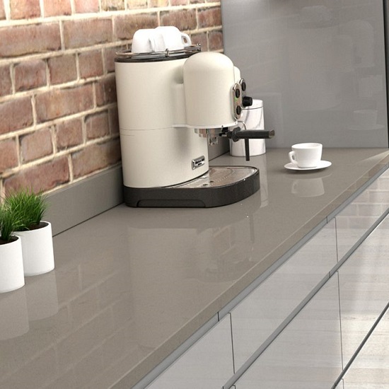 a CRL Quartz Mystic Grey 20mm worktop, a white coffee machine, and a brick wall in a kitchen
