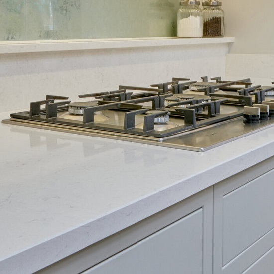 a photo of a CRL Quartz White Water kitchen worktop and a gas cooker