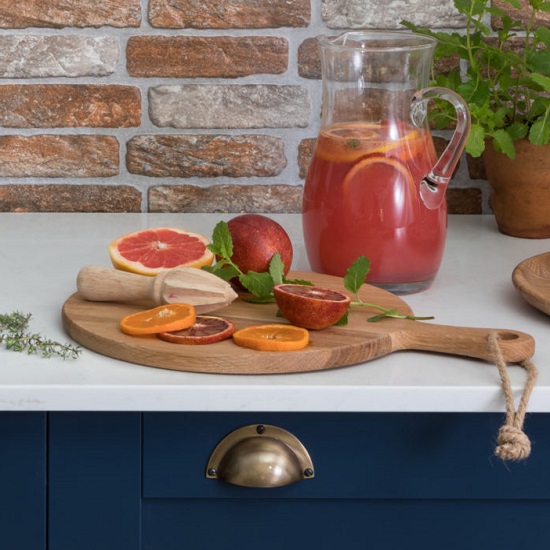 a CRL Carrara quartz worktop, a chopping board with vegetables and a jar with juice