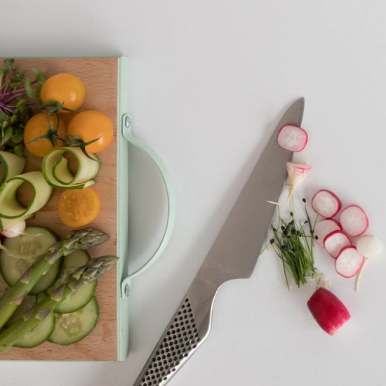 a CRL Quartz Ice worktop with a cutting board and a knife with radishes