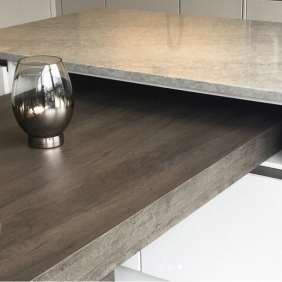 a CRL Quartz Pacific Grey 20mm worktop and a wooden breakfast bar with glass on it a