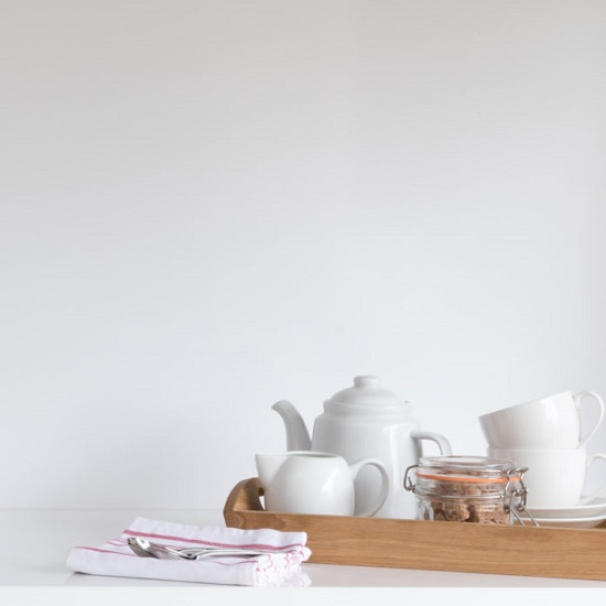 a CRL Quartz Polar White worktop and matching splashback with a tea pot and cups