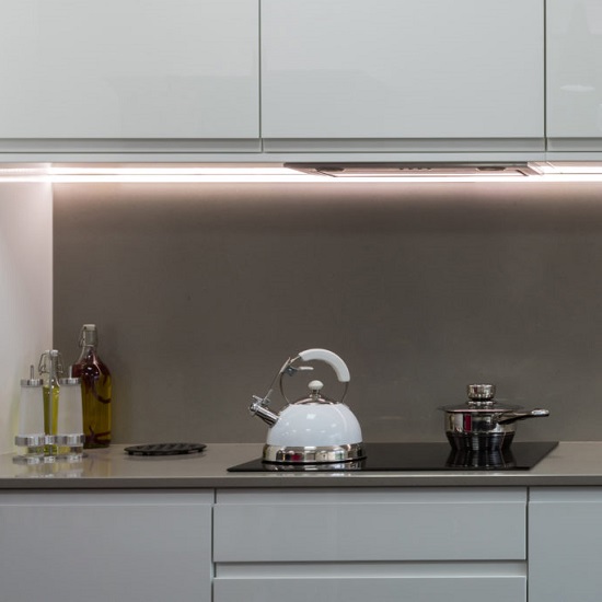 a kitchen with CRL Quartz Soft Concrete worktops, wall, and white cabinets