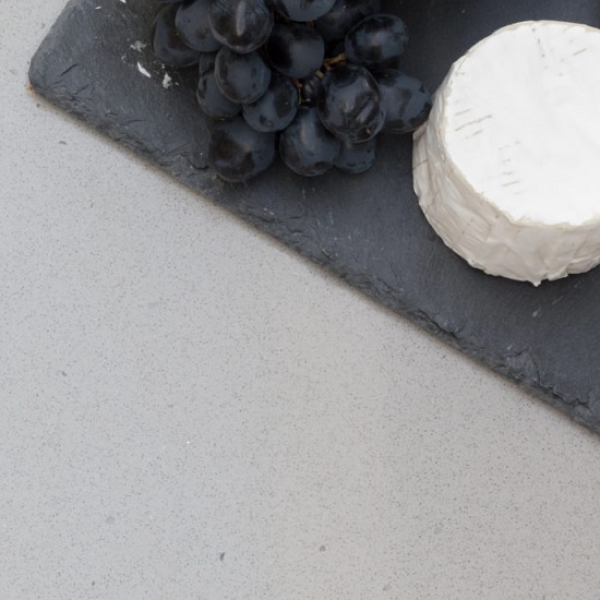 a CRL Quartz Soft Concrete kitchen worktop and a cutting board with grapes and cheese