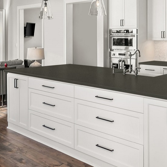 a kitchen island with white cabinets and CRL Quartz Urban Grey worktops