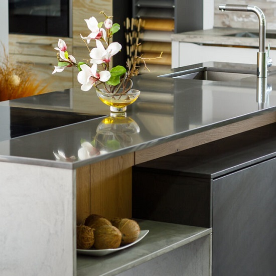 a photo of a Quartzforms Cloudy Black quartz worktop in a polished finish with flowers
