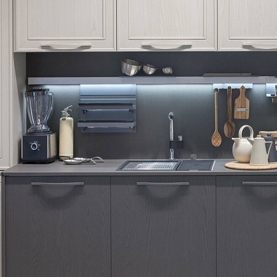 a kitchen with Quartzforms Cloudy Black quartz worktops and appliances on it