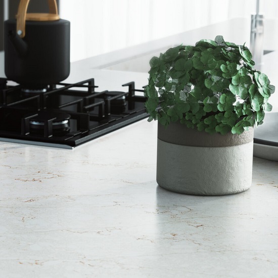 a photo of Quartzforms Forest Sughero quartz worktops with a black hob and a pot with a green plant
