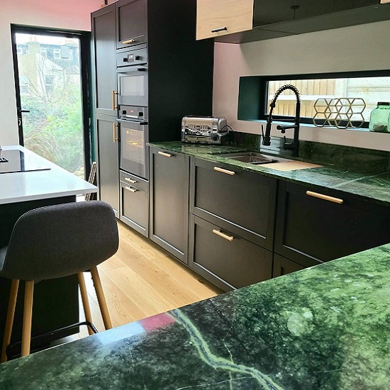a photo of a modern kitchen with Ming Green marble countertops