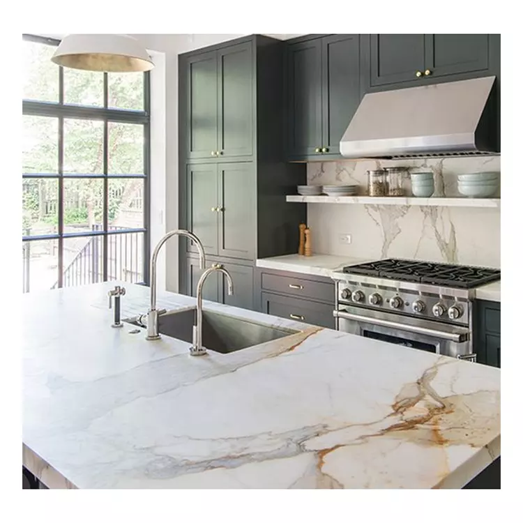 a photo of a kitchen with Calacatta Oro marble island, worktops and splashback