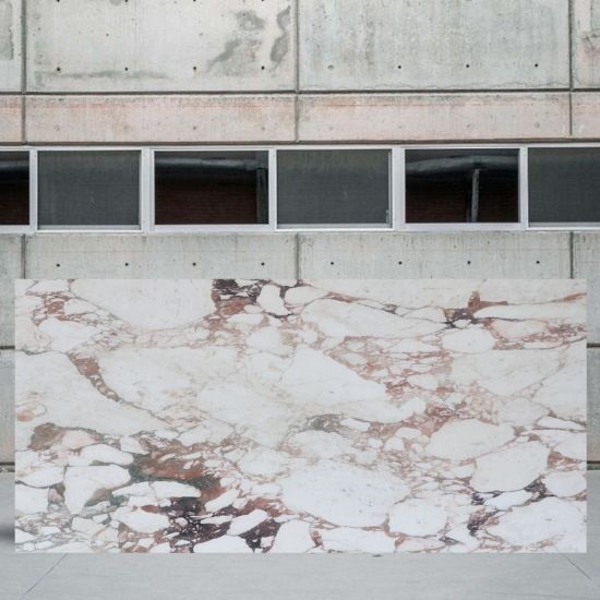 an image of a Calacatta Vagli Oro marble slab in a yard
