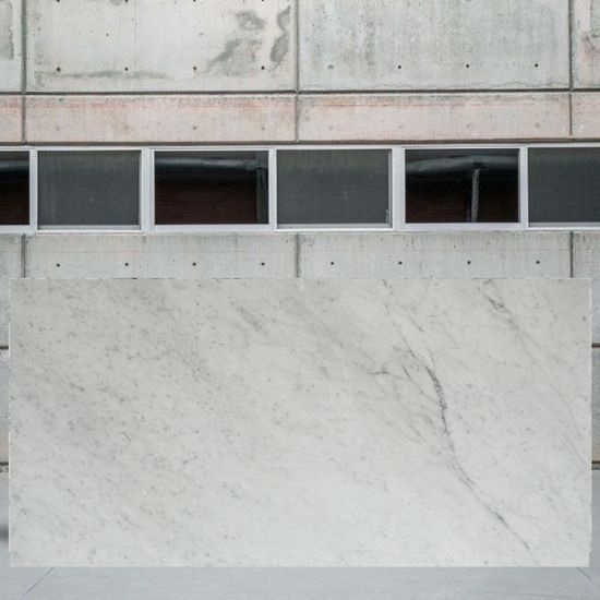 an image of a Carrara C Extra 1st marble slab outside a stone yard
