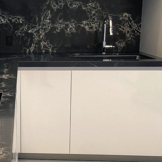 a modern kitchen with Compac Ice Black worktops and walls