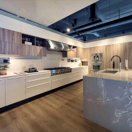 photo of a kitchen with Compac Ice White quartz kitchen island and white worktops