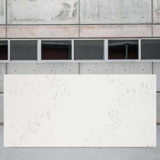 an image of a Compac Unique Bianco slab and a concrete wall behind