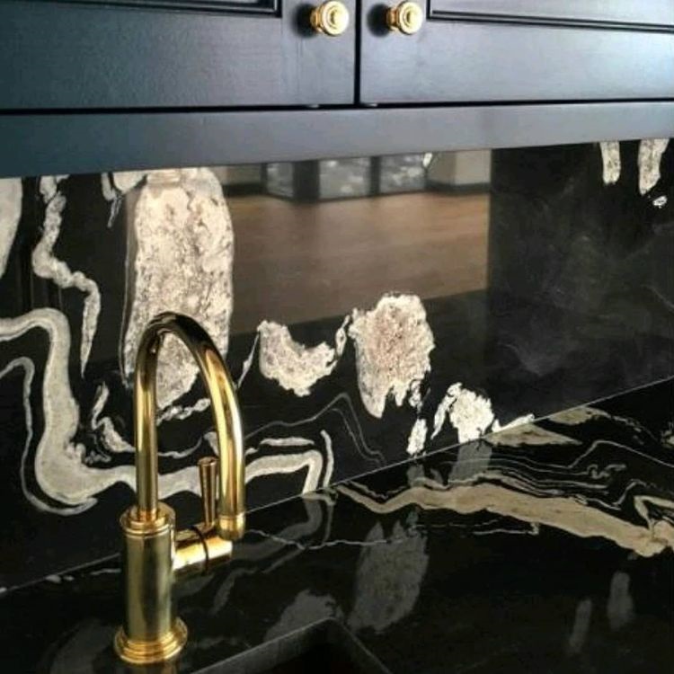 a photo of a Copacabana quartzite worktop and matching splashback and a golden faucet