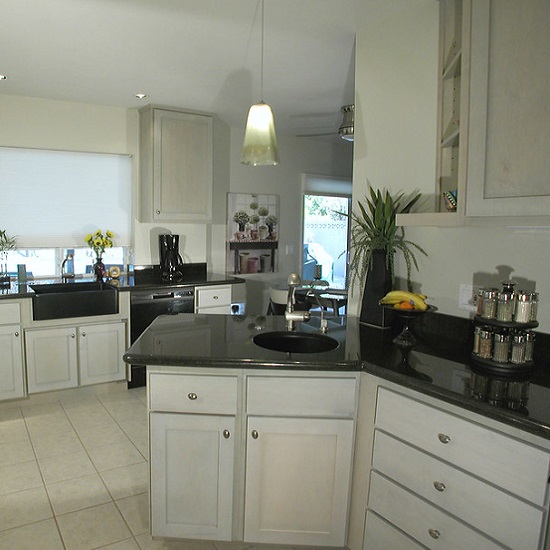 a photo of a white kitchen with Steel Grey granite polished worktops