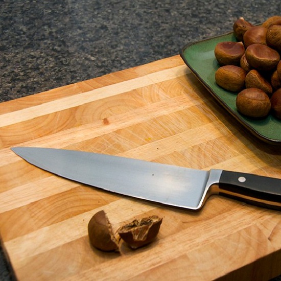 a Steel Grey granite kitchen worktop, a chopping board, a knife and mushrooms